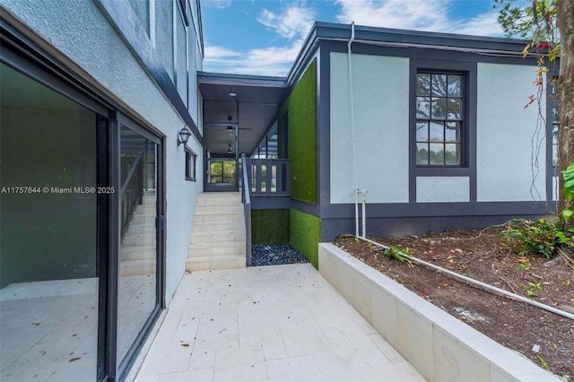 view of side of property featuring a patio area and stucco siding