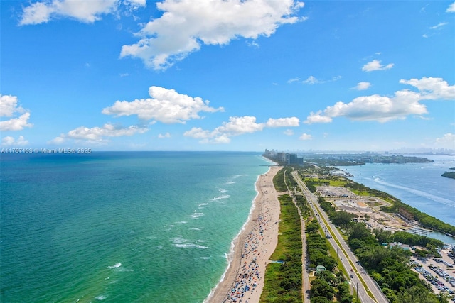 drone / aerial view featuring a beach view and a water view