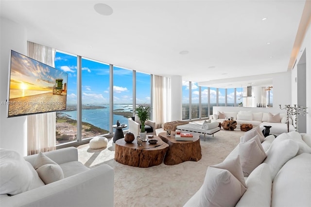 living area featuring a wall of windows and carpet flooring