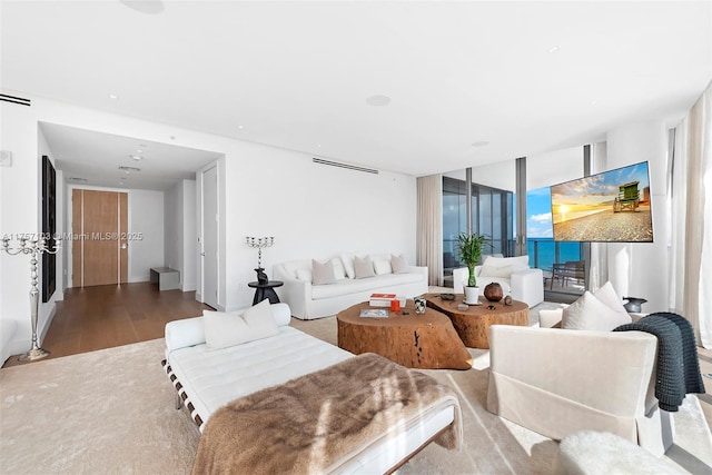 living area featuring visible vents and wood finished floors