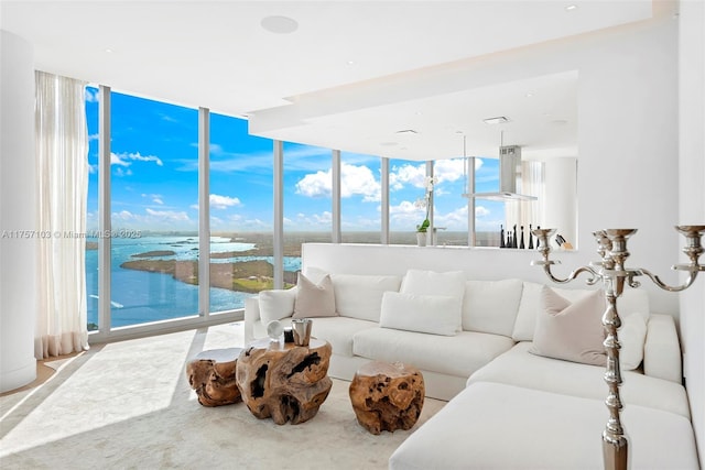 living room with a water view and a wall of windows