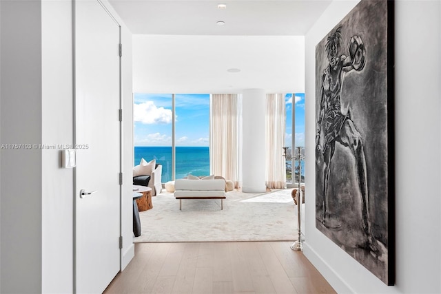 corridor featuring a water view and wood finished floors