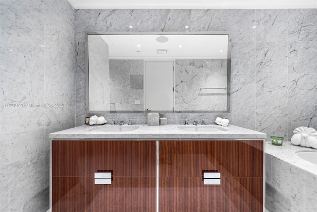 bathroom with double vanity, tile walls, and a sink