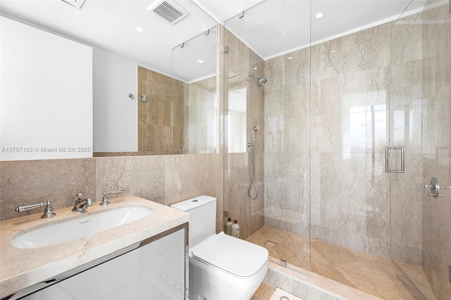 bathroom featuring tile walls, visible vents, a shower stall, and toilet