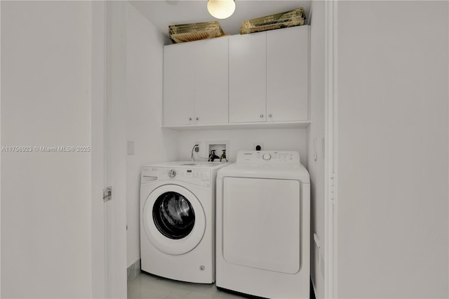 washroom featuring cabinet space and washing machine and dryer