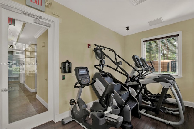 exercise room featuring wood finished floors and baseboards