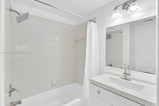 bathroom with shower / tub combo, visible vents, and vanity