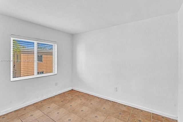 spare room featuring baseboards