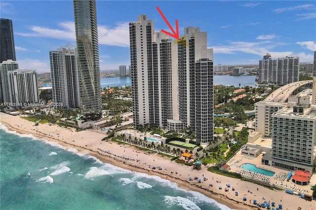 aerial view featuring a city view, a water view, and a beach view