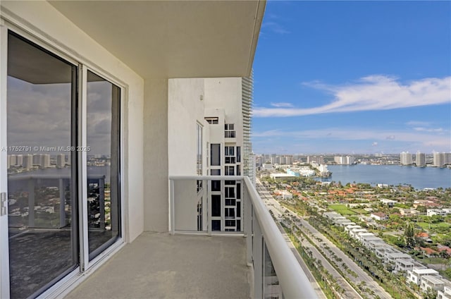 balcony featuring a view of city and a water view