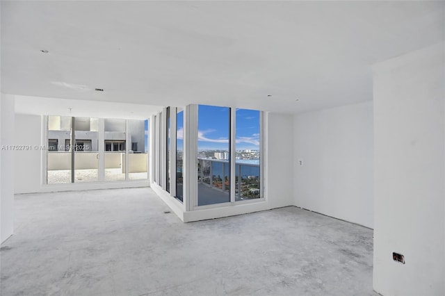 spare room featuring unfinished concrete flooring