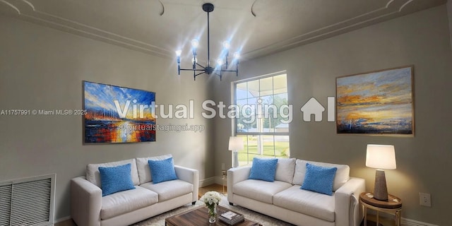 living room with a chandelier, visible vents, and baseboards