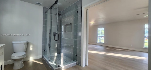 bathroom featuring a stall shower, visible vents, and wood finished floors