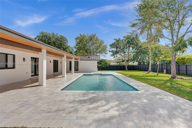 view of swimming pool with a yard, a patio area, a fenced backyard, and a fenced in pool