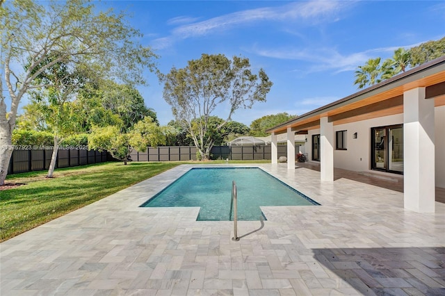 view of swimming pool with a fenced in pool, a patio area, a lawn, and a fenced backyard