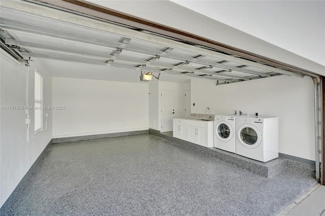 garage featuring washing machine and dryer and baseboards