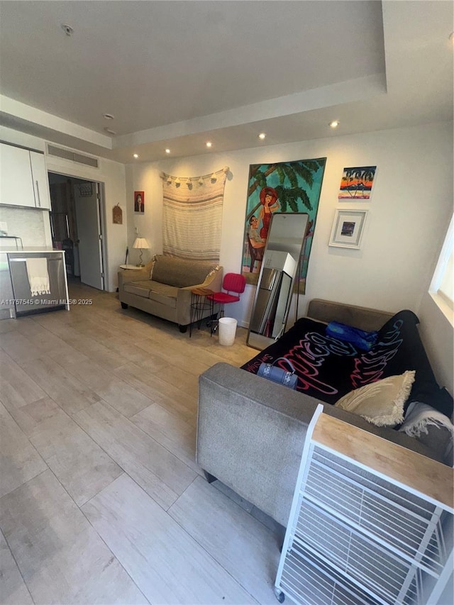 living room featuring light wood-style flooring and recessed lighting
