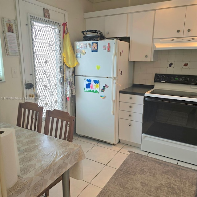 kitchen with freestanding refrigerator, electric stove, white cabinetry, and under cabinet range hood