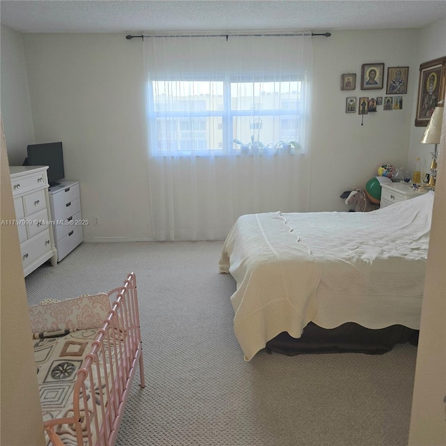 bedroom featuring carpet floors and a textured ceiling