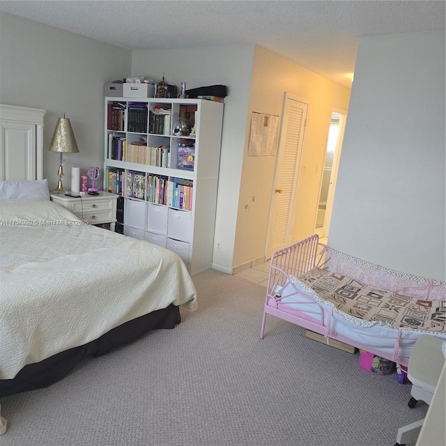 carpeted bedroom with a textured ceiling