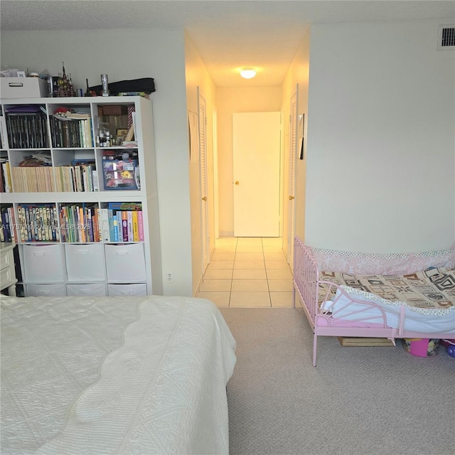 tiled bedroom with carpet flooring