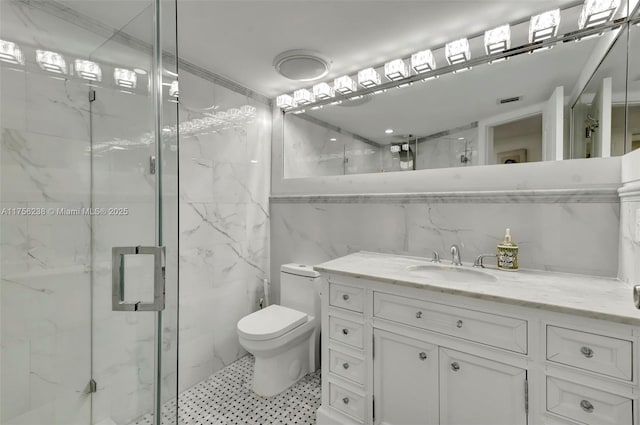 full bath featuring toilet, vanity, a marble finish shower, and tile walls