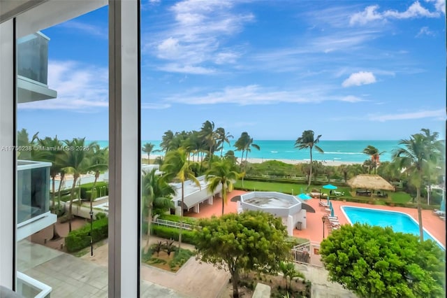 exterior space with a water view and a beach view