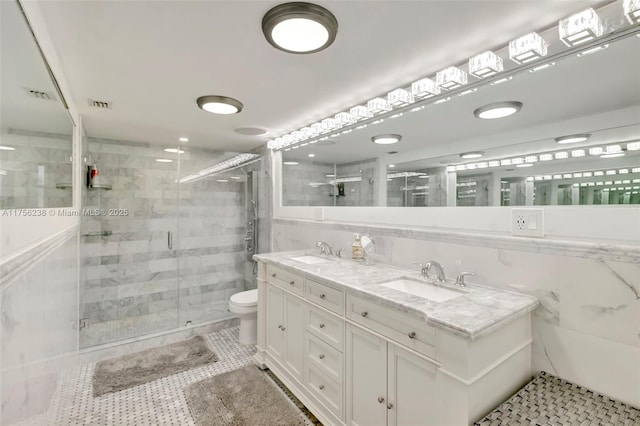 full bath featuring tile patterned floors, a sink, toilet, and a shower stall