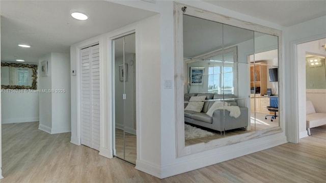 interior space with wood finished floors and baseboards