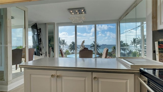 kitchen featuring a chandelier and white cabinets