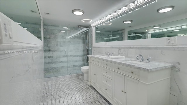 full bath featuring a stall shower, a sink, and tile walls