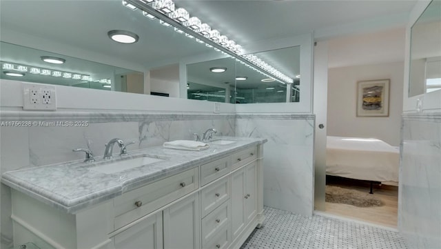 bathroom featuring tasteful backsplash, a sink, and double vanity