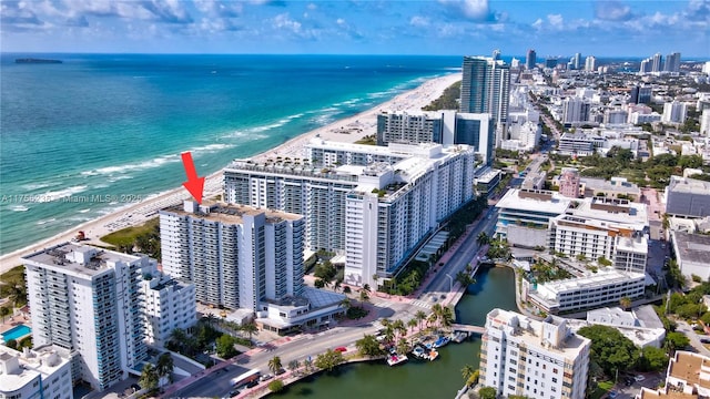 drone / aerial view featuring a view of city and a water view