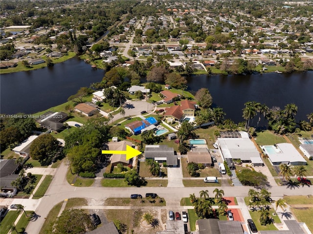 drone / aerial view with a residential view and a water view