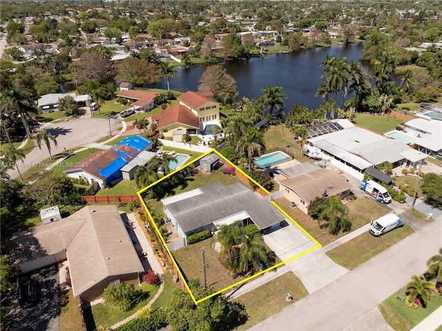 birds eye view of property with a water view and a residential view