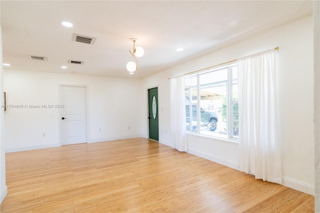 spare room featuring recessed lighting, visible vents, light wood-style flooring, and baseboards