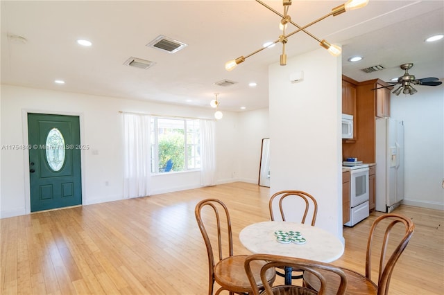 dining room with light wood-type flooring, visible vents, and recessed lighting