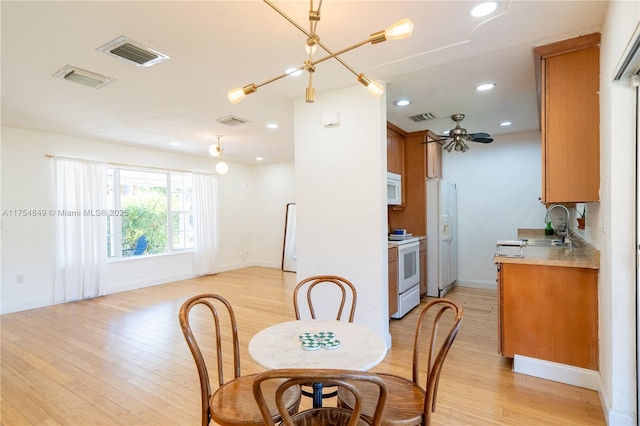 dining room featuring light wood-type flooring, visible vents, and recessed lighting