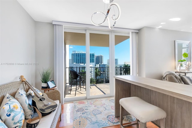 interior space featuring a view of city, floor to ceiling windows, and an inviting chandelier