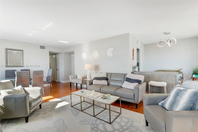 living room featuring wood finished floors and visible vents