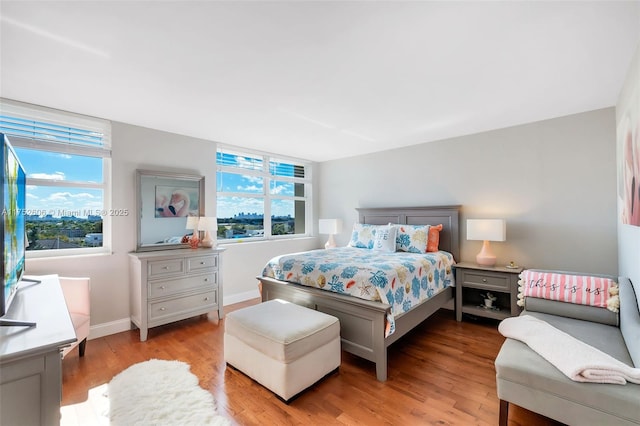 bedroom featuring baseboards and wood finished floors