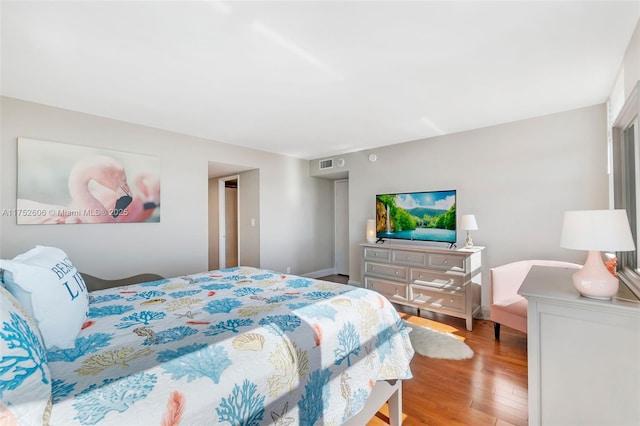 bedroom featuring visible vents and light wood-style flooring