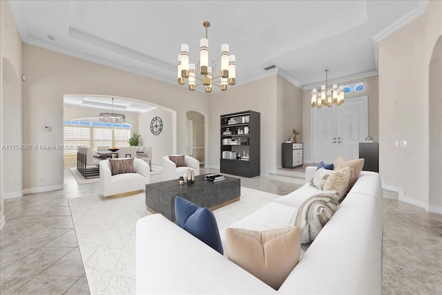 living room with a chandelier, ornamental molding, arched walkways, and visible vents