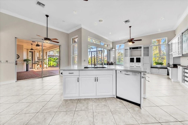 kitchen featuring light tile patterned floors, crown molding, visible vents, and dishwasher