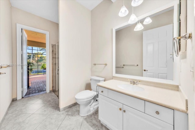 bathroom featuring a stall shower, baseboards, toilet, tile patterned floors, and vanity