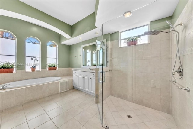 bathroom with tile patterned flooring, vanity, visible vents, a shower stall, and a bath