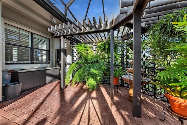 wooden deck featuring a patio area and a pergola