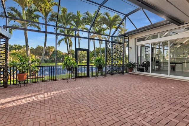 unfurnished sunroom featuring a water view