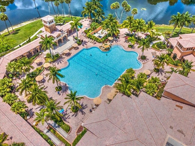 view of swimming pool featuring a patio area and a water view