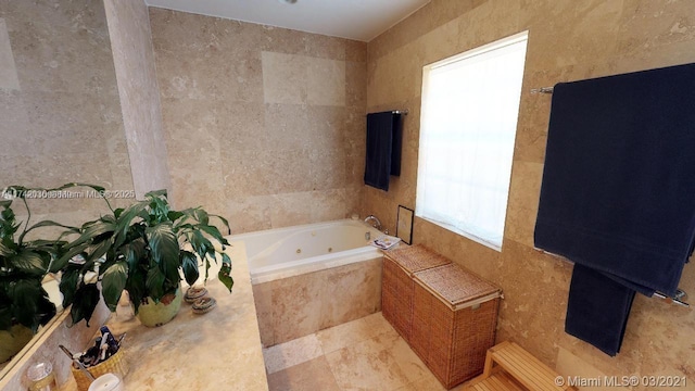 full bath featuring a jetted tub and tile walls